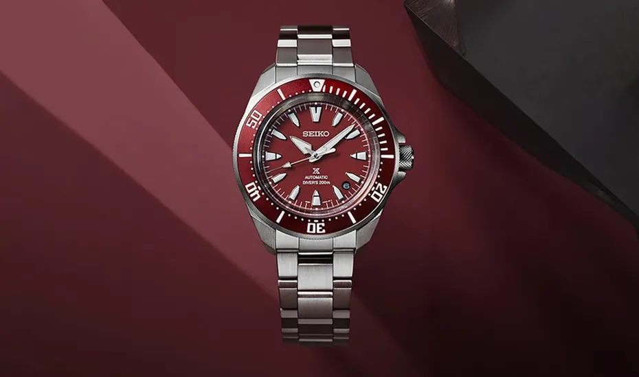 Red-dial Seiko dive watch on red-black backdrop display
