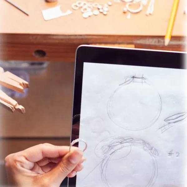Jewelry design sketch with artisan holding a diamond ring